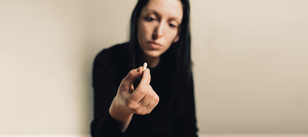 a woman taking opiate medication